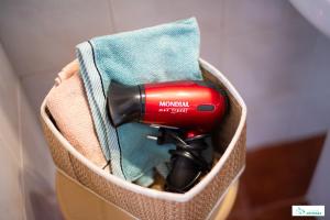 a blow dryer in a basket with a towel at Living Artenara - EARTH Adults Only in Artenara