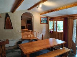 a dining room with wooden tables and a staircase at Chalet Le Grand Méan in Bonneval-sur-Arc