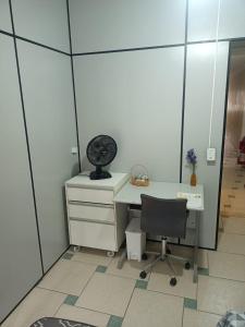 an office with a desk and a chair and a mirror at quarto 05 solteiro aconchegante a 2 km de Alphaville in Barueri