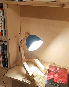 a lamp sitting on top of a table with books at Hsinchu Book&Bed in Hsinchu City