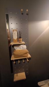 a bathroom with a wall with shelves and towels at Hsinchu Book&Bed in Hsinchu City
