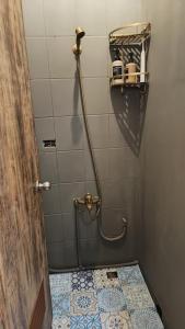 a bathroom with a shower with a tiled floor at Hsinchu Book&Bed in Hsinchu City