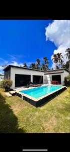 a large swimming pool in front of a house at Eden villas in Nathon Bay +4 photos
