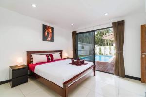 a bedroom with a bed and a pool at Eden villas in Nathon Bay