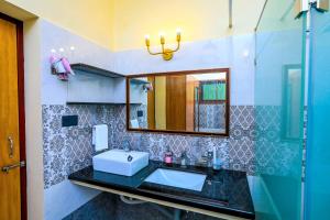 a bathroom with a sink and a mirror at Bay Homes 2BHK WT Bathtub Near Rock Beach in Puducherry