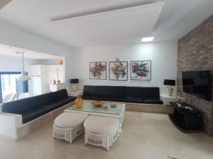 a living room with a couch and a table at Apartamento Faro de Sardina in Gáldar