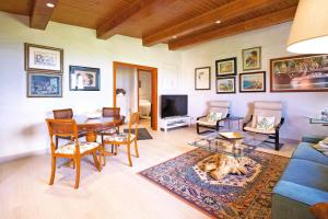a living room with a blue couch and a table at La Casa de Arriba in Arucas