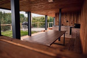 a wooden table in a room with a large window at Chata Scheelit in Banská Štiavnica