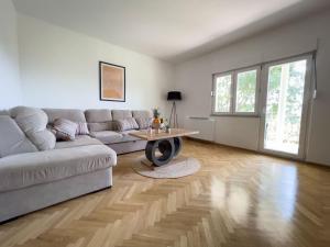a living room with a couch and a table at Villa Ellie in Ljubuški