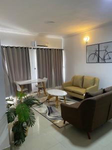 a living room with a couch and a table at Novara Apartments in Lekki