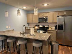 a kitchen with a large island with bar stools at Urban Oasis in University City in Philadelphia