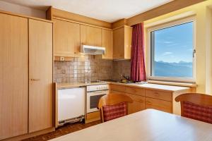 a small kitchen with a table and a window at Apt Waldblick in Maranza