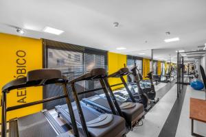 a gym with a row of cardio machines at All You Need in Curitiba