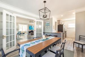 a dining room and living room with a table and chairs at The 1920’s Dutch Colonial - Highland Square in Akron