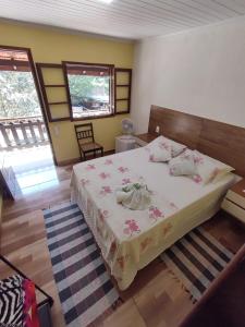 a bedroom with a large bed in a room at Pousada Cantinho do Vale in Penedo