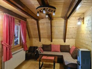 a living room with a couch in a cabin at Eko katun Mirac in Danilovgrad