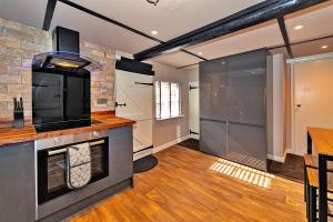 a kitchen with a stove and a counter top at Finest Retreats - Chocolate Box Cottage in Potton