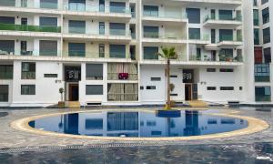an empty pool in front of a building at Cosy Bay appartement 4 - 5px in Agadir