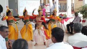 a group of women performing a performance in front of a crowd at Hotel Kintop in Udugama