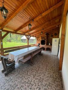 a large wooden pavilion with a large pool table at Lenilla Guesthouse in Şiclod