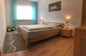 1 dormitorio con 1 cama y una ventana con cortinas azules en Walli Laterns, en Laterns