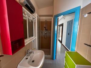 a bathroom with a sink and a shower at Casa Li Cossi vicino al mare in Costa Paradiso