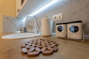 a counter with chocolate cookies and a sink in a bathroom at Apartman Grand Zlatibor in Zlatibor