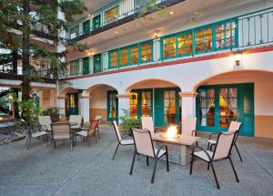 a patio with chairs and a table in front of a building at Quality Suites Downtown San Luis Obispo in San Luis Obispo