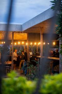a group of people sitting in a restaurant at night at Tugende Hostel in Kigali