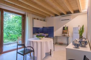 a kitchen with a table and chairs and a window at In Riva al Lago di Iseo Dependance Piano Terra in Marone +44 photos