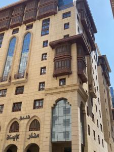 a tall building with windows on the side of it at فندق منار الإيمان in Medina