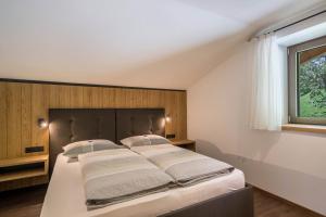 Postel nebo postele na pokoji v ubytování Sunnseitn Lodge Apt Mountainsuite