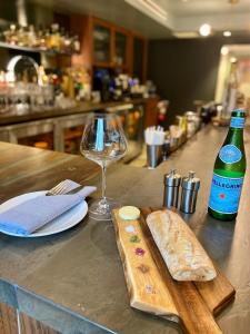 a counter with a bottle of wine and a bread and a glass at Kimpton Banneker Hotel, an IHG Hotel in Washington