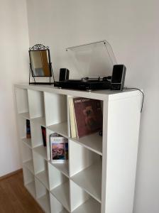 a white shelf with a laptop on top of it at Nomad Apartments in Prague