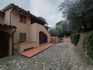 a house with a stone driveway in front of it at Villa Utilia into the wild in Perugia