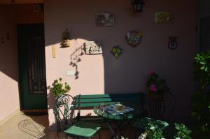 a patio with a table and two chairs and a table at L'Oasi delle Vigne in Rome +50 photos