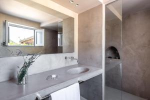 a bathroom with a sink and a mirror at Vico San Lorenzo - Camere a Salina in Malfa