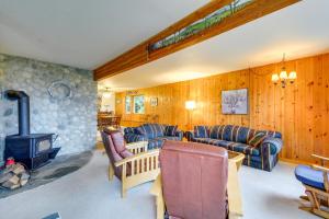 a living room with a couch and a stove at Tahuya Cabin Hood Canal and Olympic Mountain Views! in Tahuya