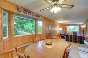 a dining room with a large wooden table and chairs at Tahuya Cabin Hood Canal and Olympic Mountain Views! in Tahuya