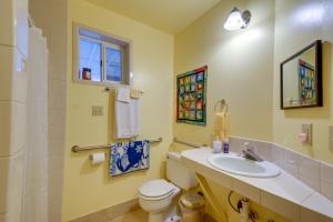 a bathroom with a sink and a toilet and a window at Tahuya Cabin Hood Canal and Olympic Mountain Views! in Tahuya +28 photos