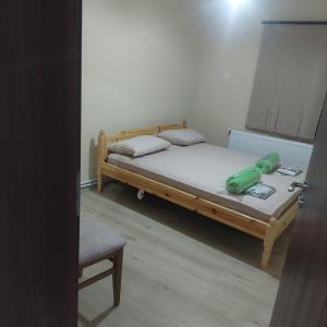 a small bedroom with a bed and a chair at Guest Rooms Didka in Koprivshtitsa