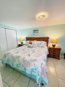 A bed or beds in a room at Cozy Canaveral Cottages