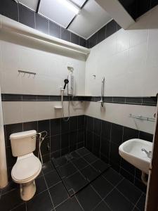 a bathroom with a toilet and a sink at Big Dreams Double Story House in Tanah Rata