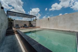 a swimming pool in the backyard of a house at Hotel Mexico, Merida in Mérida