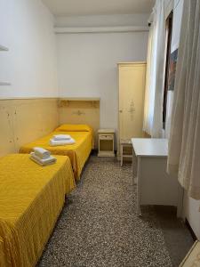 A bed or beds in a room at Alloggi Gerotto Calderan 2