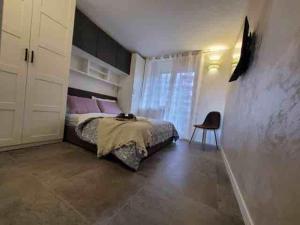 a bedroom with a bed and a chair in it at Alpine House in Sauze dʼOulx