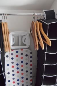 a closet with a polka dot suitcase and hangers at Cosy self-contained flat in Kirriemuir in Kirriemuir