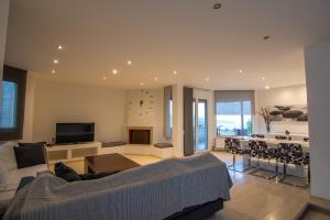 a living room with a couch and a table at Cicada 4 Bedroom Villa in Palaiokastro