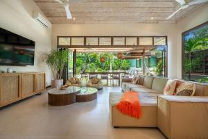 a living room with a couch and a table at Casa Cheetah Main House and Casita in Tamarindo