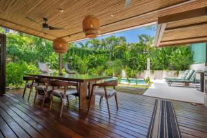 a dining room with a table and chairs on a deck at Casa Cheetah Main House and Casita in Tamarindo